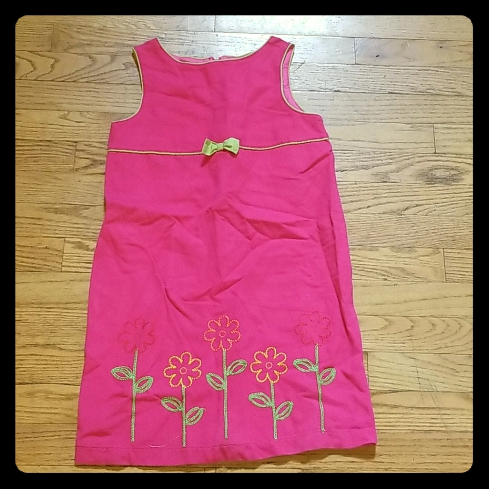 A pink and green dress with a cute flower design